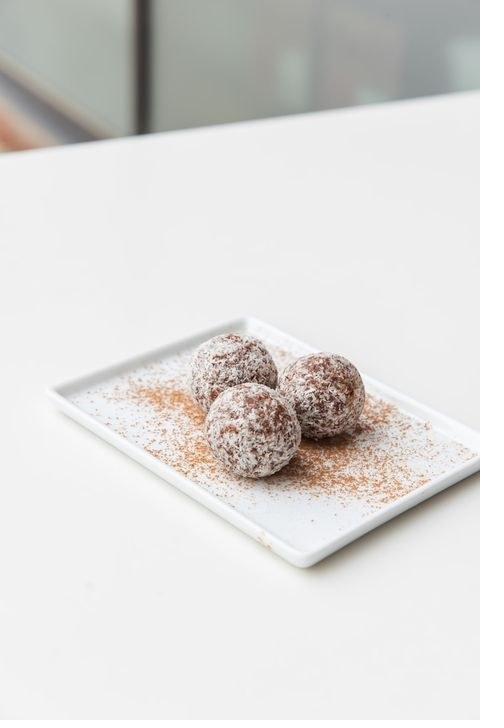 E+ROSE booster bites rolled in coconut flakes with a dusting of cinnamon