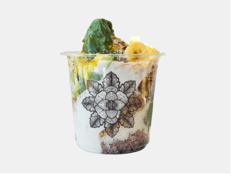 E+ROSE Matcha Bowl — green matcha blend with banana, granola, and coconut in a lotus-print cup