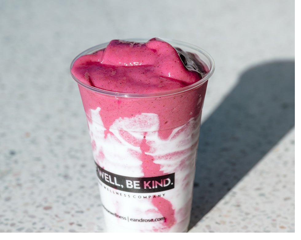 The pink smoothie in an E+ROSE cup, on terrazzo in the sun